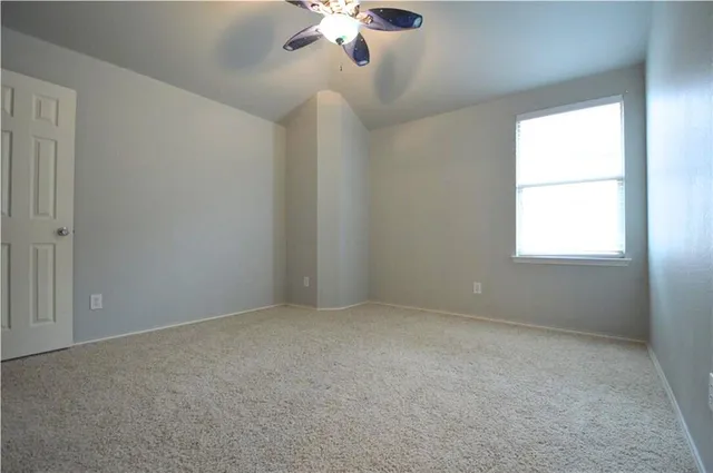 a bedroom with a bed and a lamp