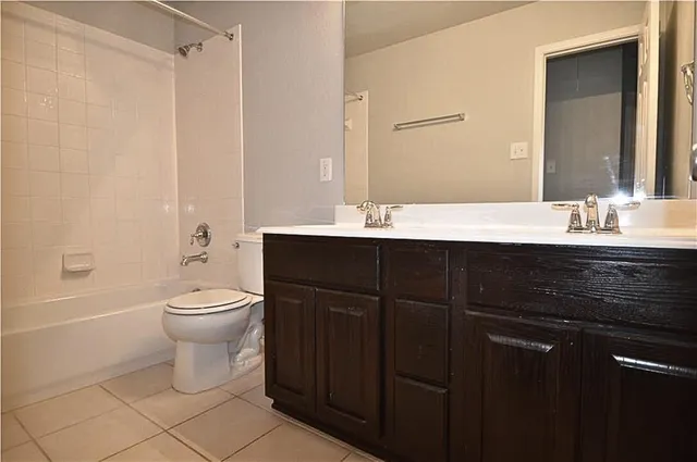a spacious bedroom with a bed and a chandelier