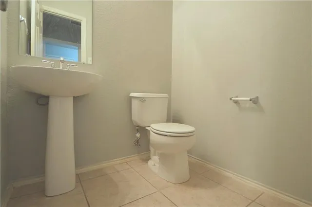 a bathroom with a double vanity sink toilet and a mirror