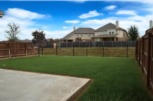 a view of a brick house with a yard