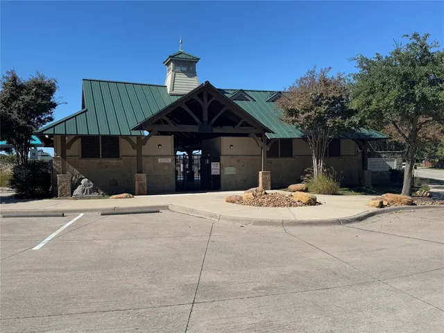 a view of a park with a big yard and potted plants