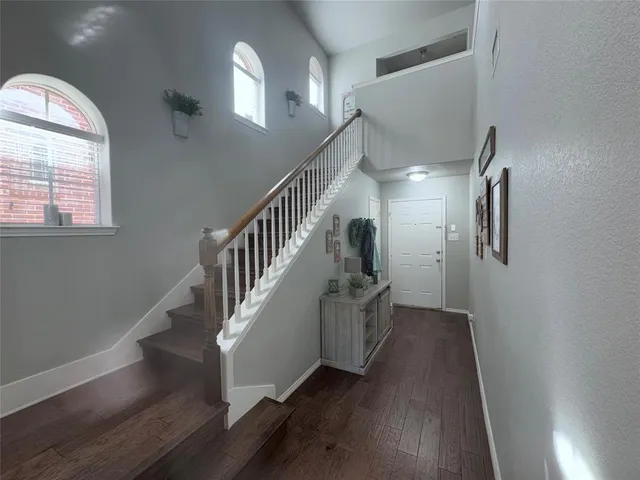 a view of entryway and hall with wooden floor