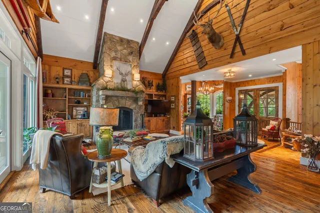 a bedroom with a bed a couch and a large window