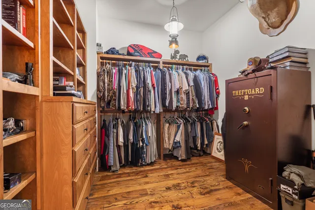a view of an entryway with wooden floor and front door