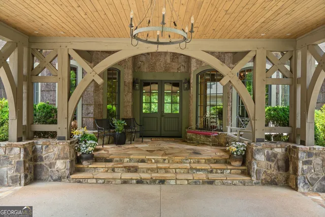 a living room with furniture fireplace and potted plants