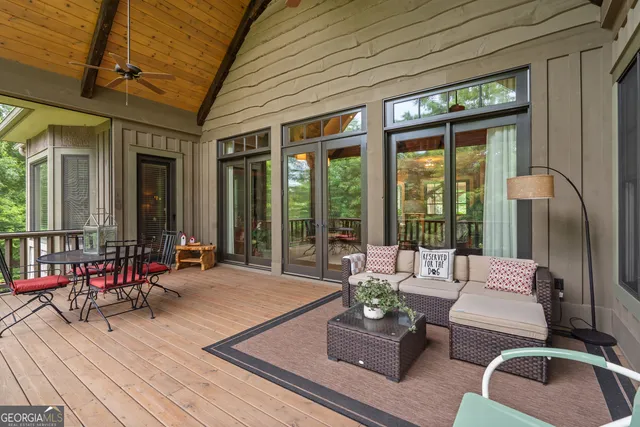 a dining room with furniture water view and outdoor space