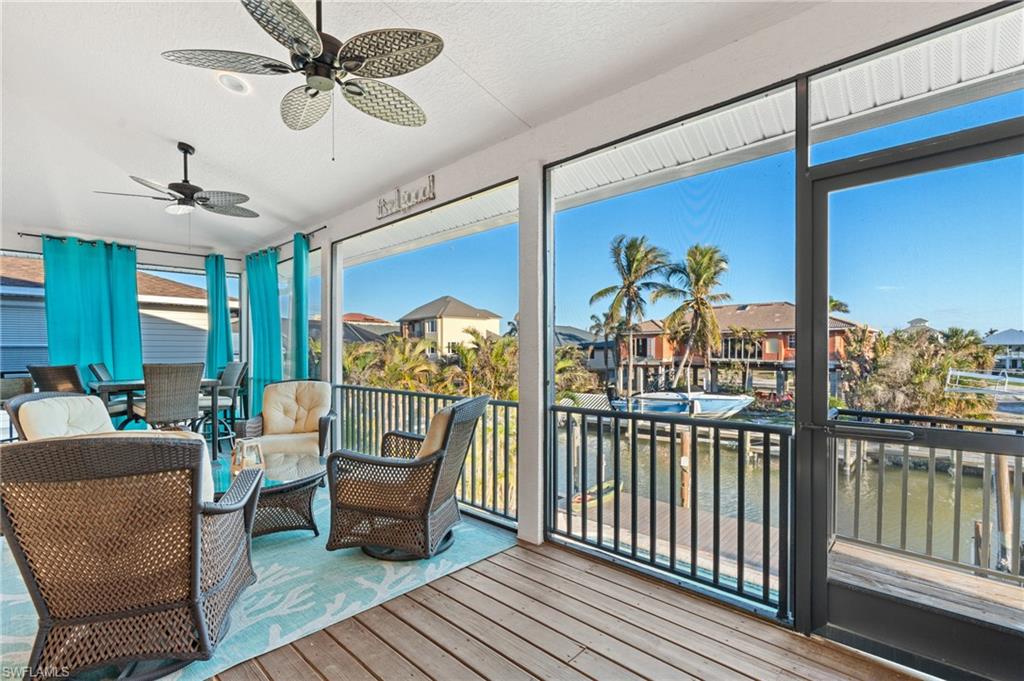 256 Curlew Street Fort Myers Beach, FL 33931 - Photo 15 of 43 Sunroom / solarium with ceiling fan. virtually enhanced photo