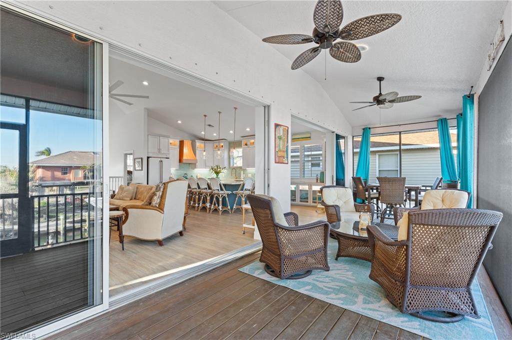 256 Curlew Street Fort Myers Beach, FL 33931 - Photo 16 of 43 Sunroom with vaulted ceiling, ceiling fan, and plenty of natural light. virtually enhanced photo