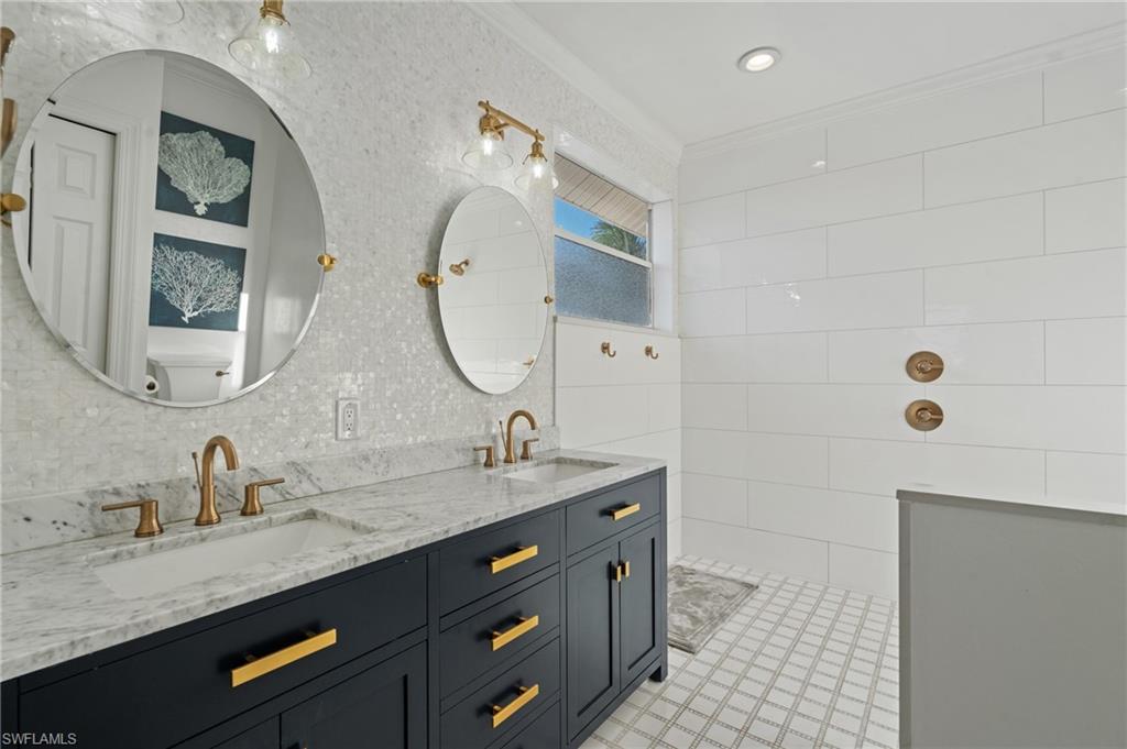 256 Curlew Street Fort Myers Beach, FL 33931 - Photo 20 of 43 Bathroom with ornamental molding and vanity. virtually enhanced photo