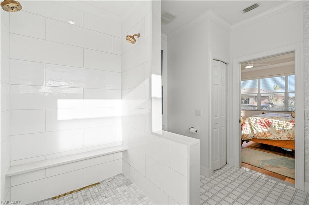 256 Curlew Street Fort Myers Beach, FL 33931 - Photo 21 of 43 Bathroom with crown molding and walk in shower. virtually enhanced photo