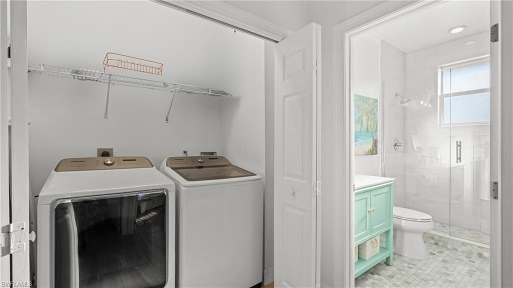 256 Curlew Street Fort Myers Beach, FL 33931 - Photo 25 of 43 Laundry room featuring separate washer and dryer. virtually enhanced photo