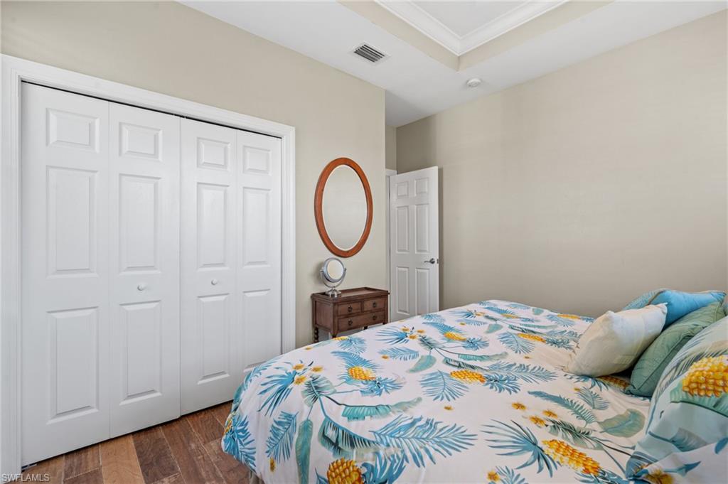 256 Curlew Street Fort Myers Beach, FL 33931 - Photo 27 of 43 Bedroom featuring crown molding and a closet. virtually enhanced photo