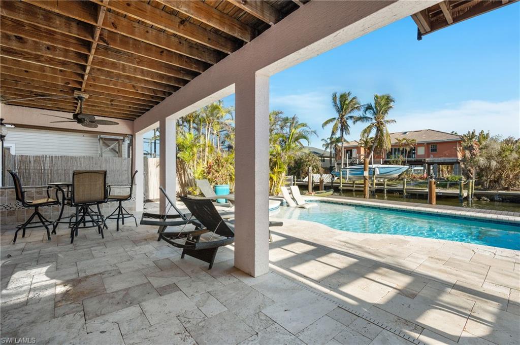 256 Curlew Street Fort Myers Beach, FL 33931 - Photo 33 of 43 View of swimming pool with a patio and ceiling fan. virtually enhanced photo