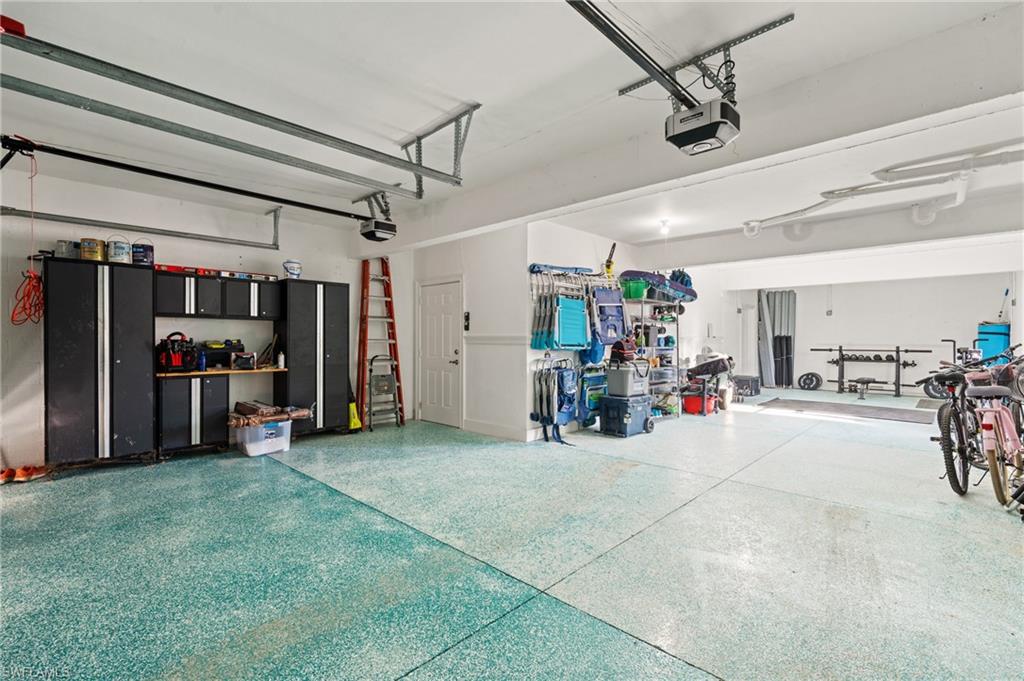 256 Curlew Street Fort Myers Beach, FL 33931 - Photo 35 of 43 Garage with a garage door opener. virtually enhanced photo