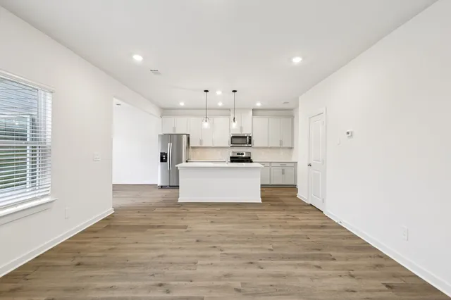 a view of kitchen with wooden floor