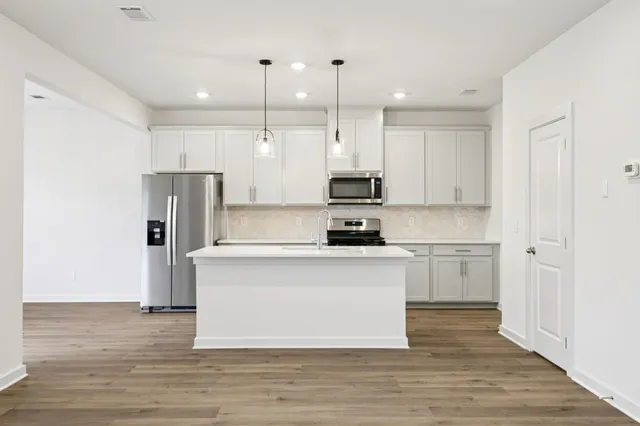 a kitchen with a stove and cabinets