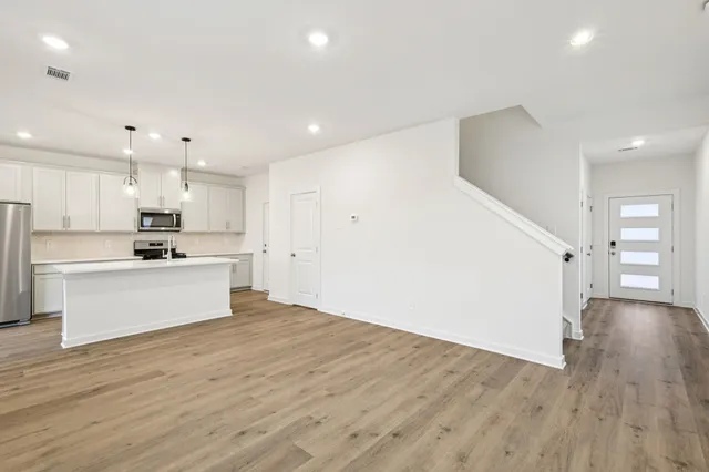 a kitchen with a sink and chandelier
