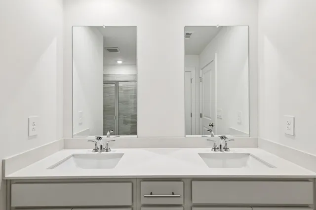 a view of a house with a large window and wooden fence