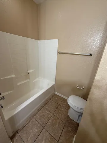 a bathroom with a toilet and a bathtub