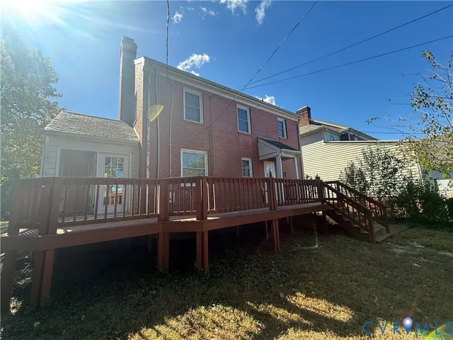 a balcony with wooden floor and outdoor seating