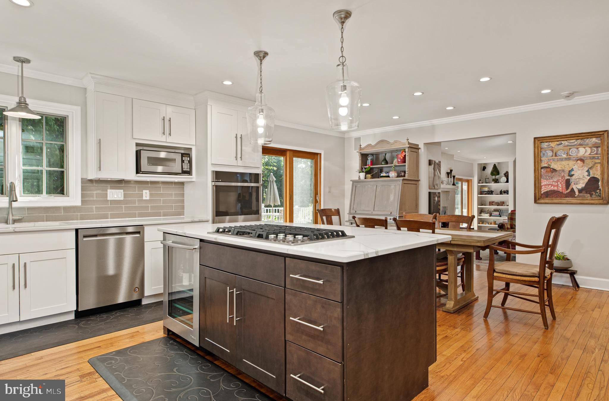 1429 Flat Rock Road Penn Valley, PA 19072 - Photo 16 of 58 a kitchen with stainless steel appliances granite countertop a stove a sink dishwasher a refrigerator and white cabinets with wooden floor