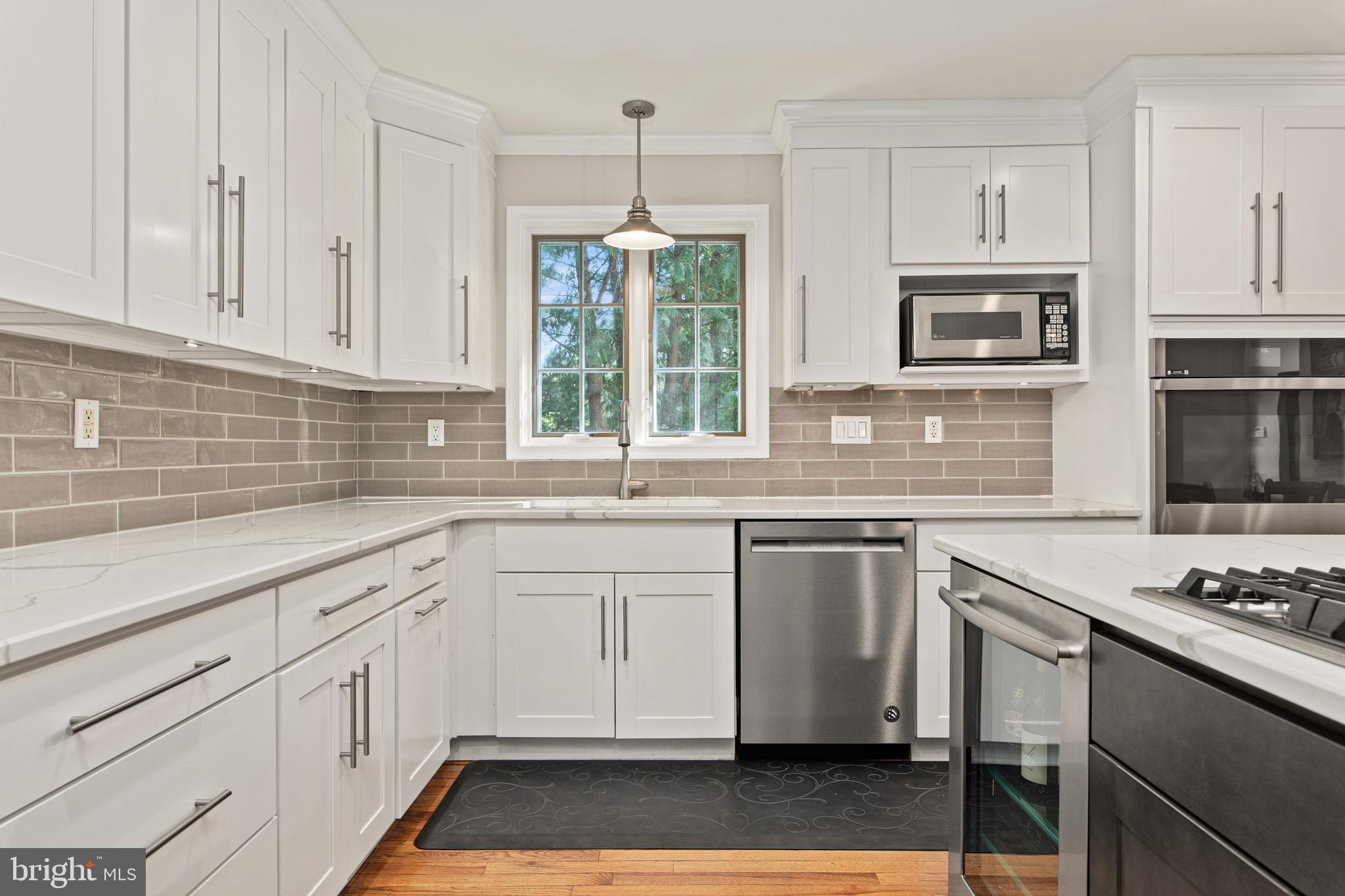 1429 Flat Rock Road Penn Valley, PA 19072 - Photo 17 of 58 a kitchen with granite countertop white cabinets and white appliances