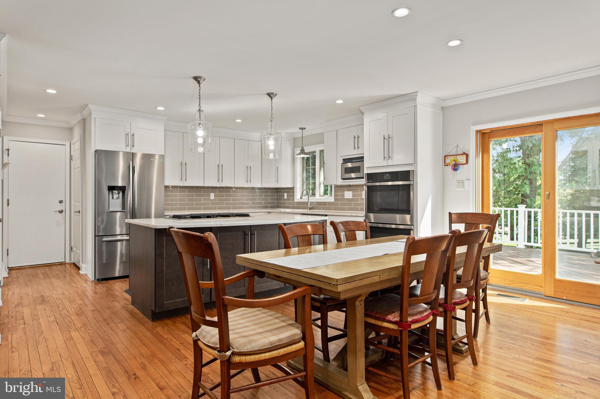 1429 Flat Rock Road Penn Valley, PA 19072 - Photo 21 of 58 a dining room with stainless steel appliances kitchen island granite countertop a dining table chairs and large window