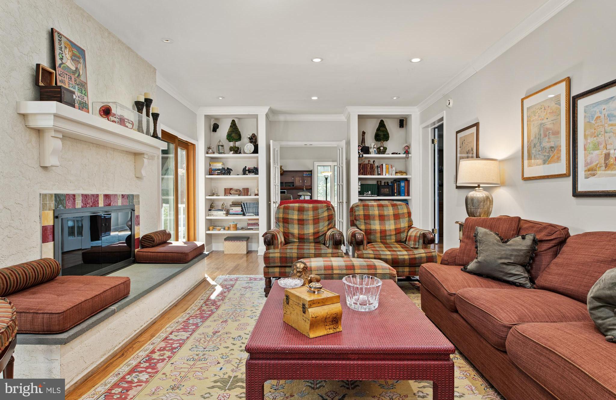 1429 Flat Rock Road Penn Valley, PA 19072 - Photo 23 of 58 a living room with furniture fireplace and a table