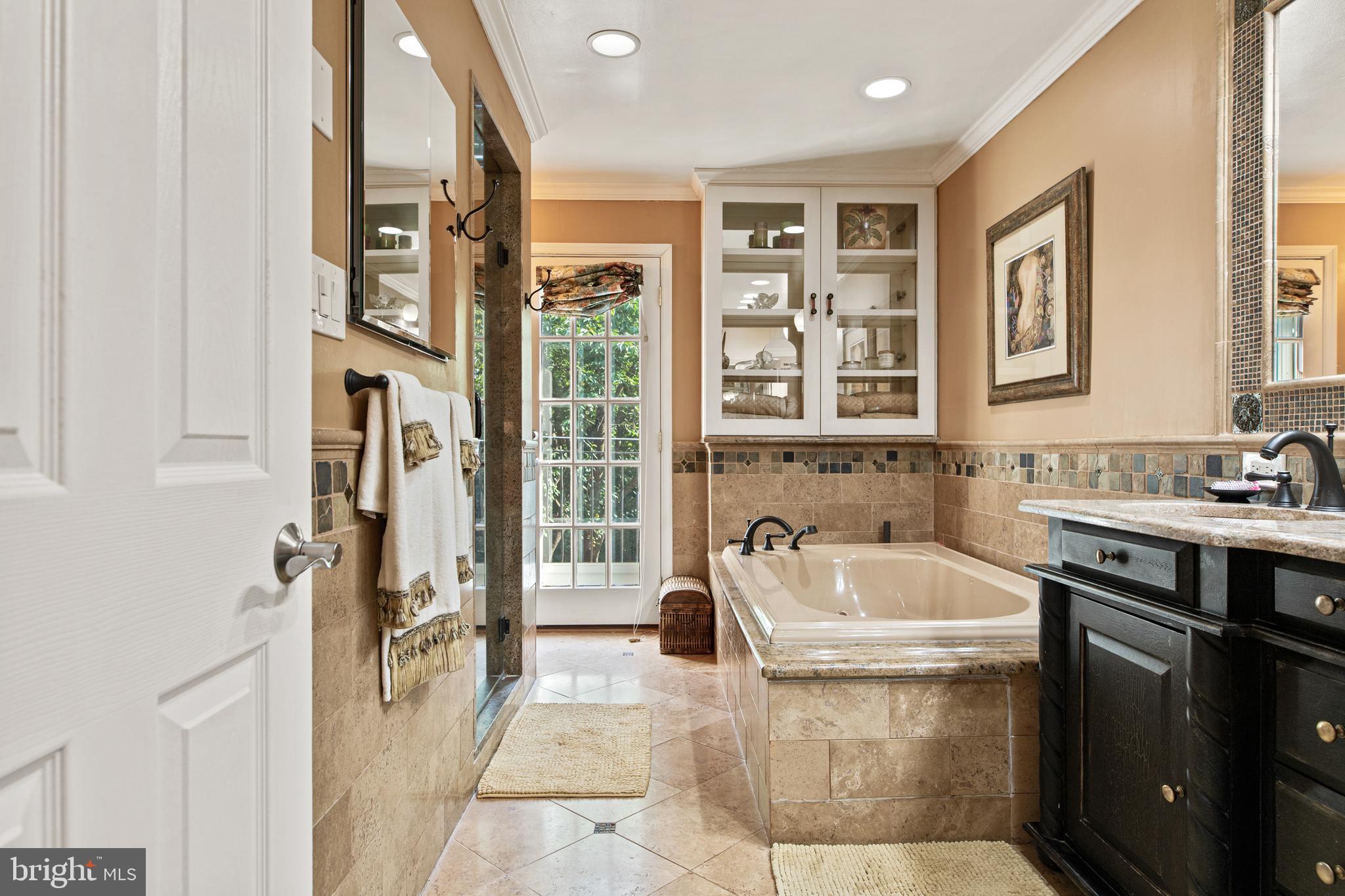 1429 Flat Rock Road Penn Valley, PA 19072 - Photo 34 of 58 a spacious bathroom with a tub sink and mirror