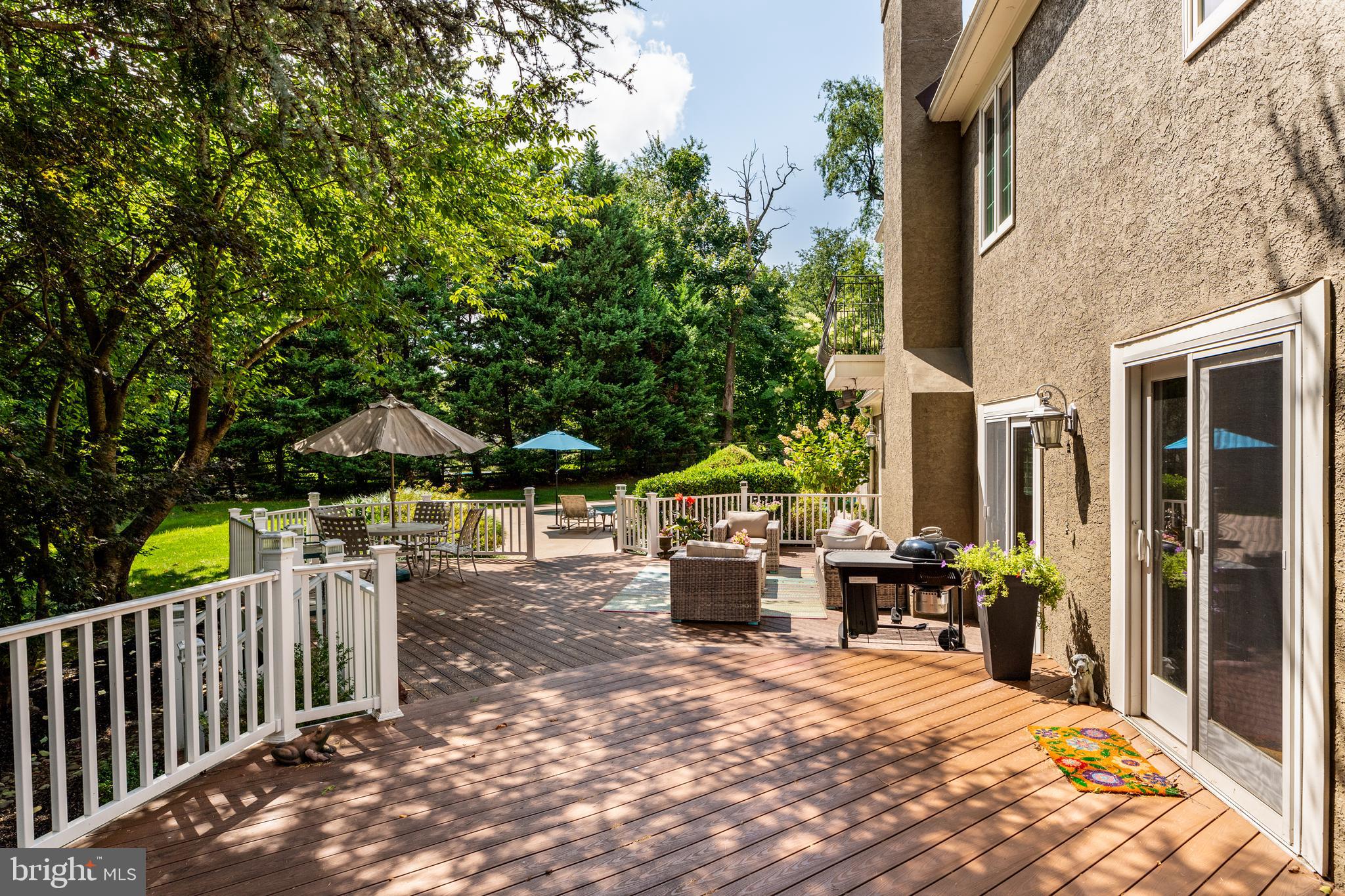 1429 Flat Rock Road Penn Valley, PA 19072 - Photo 49 of 58 a view of a patio with table and chairs under an umbrella