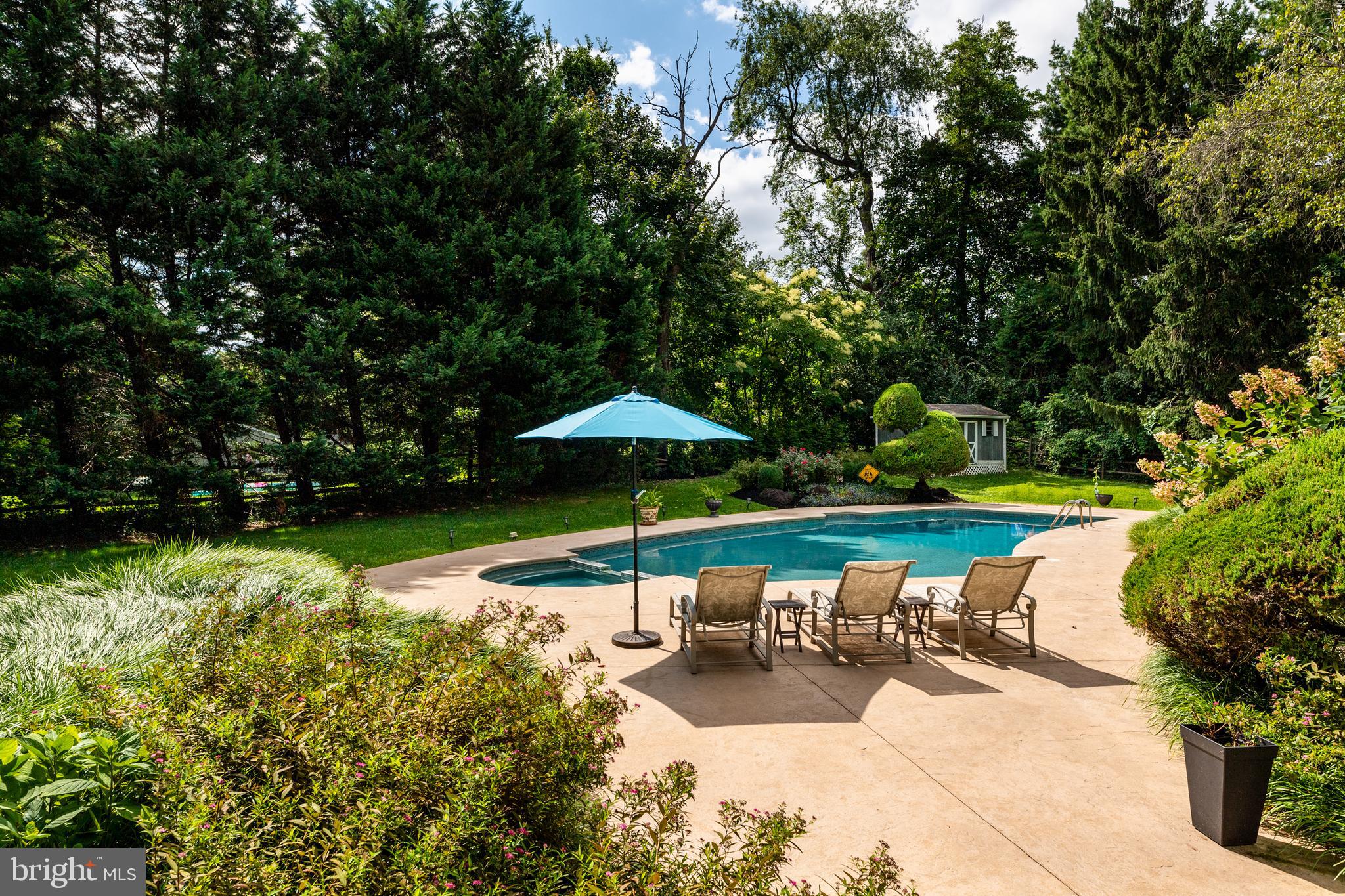 1429 Flat Rock Road Penn Valley, PA 19072 - Photo 50 of 58 a view of swimming pool with lawn chairs under an umbrella