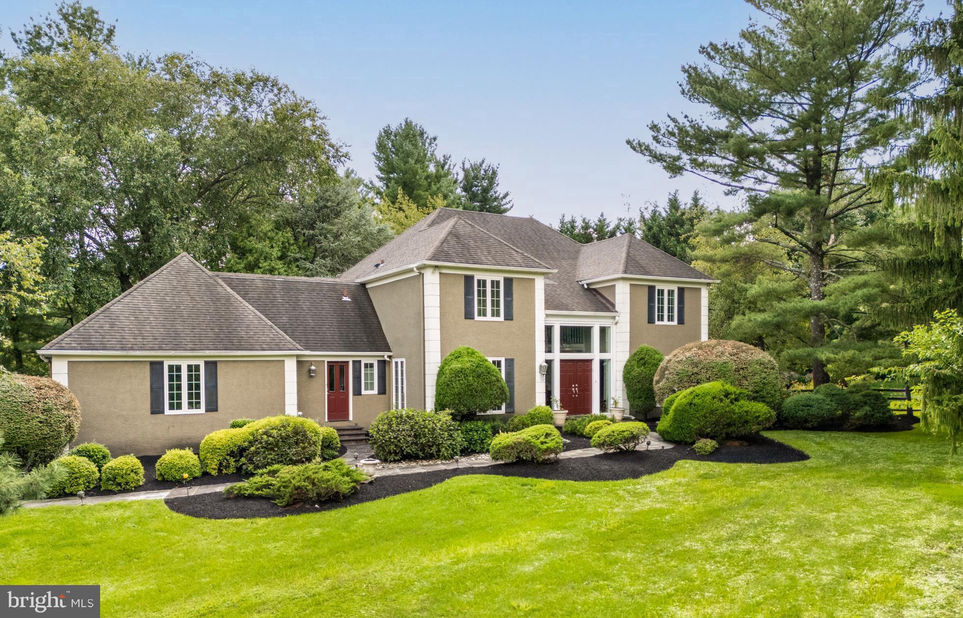 1429 Flat Rock Road Penn Valley, PA 19072 - Photo 6 of 58 a front view of a house with a yard and garage