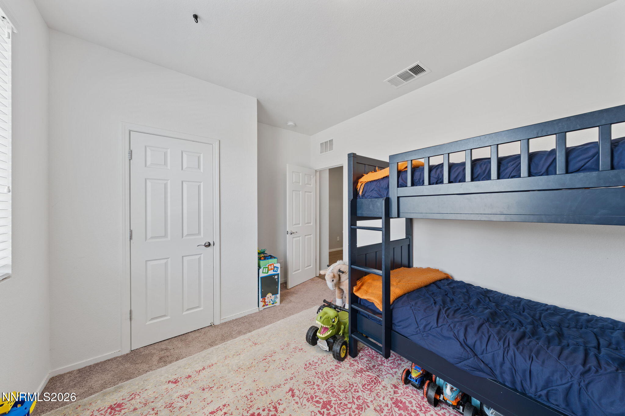 9708 Sea Glass Drive Reno, NV 89506 - Photo 11 of 51 a bedroom with furniture and a rug