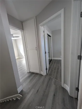 a view of a hallway with wooden floor