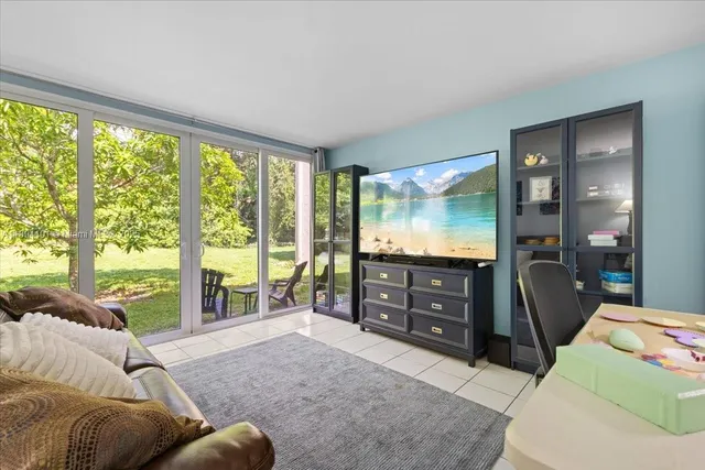 a bedroom with a balcony a bed and a large window