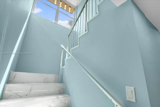 a bedroom with a bed and a flat tv screen on a table