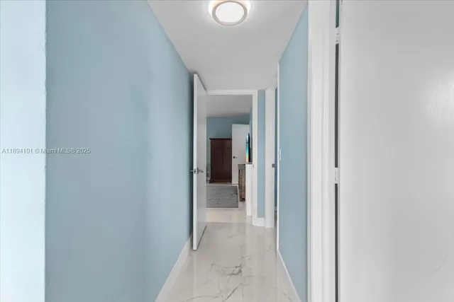 a front view of a house with a yard and potted plants