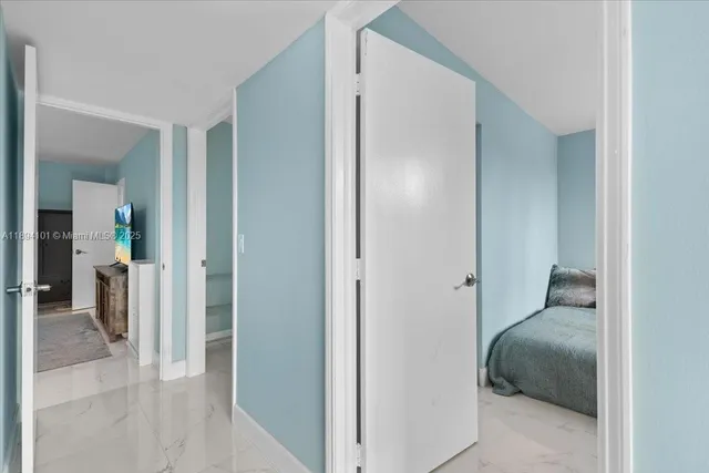 an aerial view of residential houses with outdoor space and trees all around