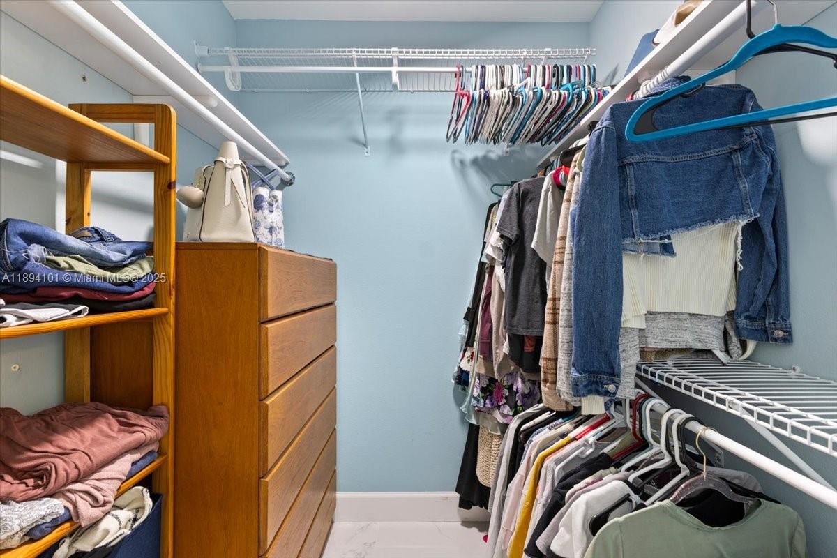 9450 Live Oak Place, Unit 109 Davie, FL 33324 - Photo 41 of 98 a view of walk in closet with clothes and shoes