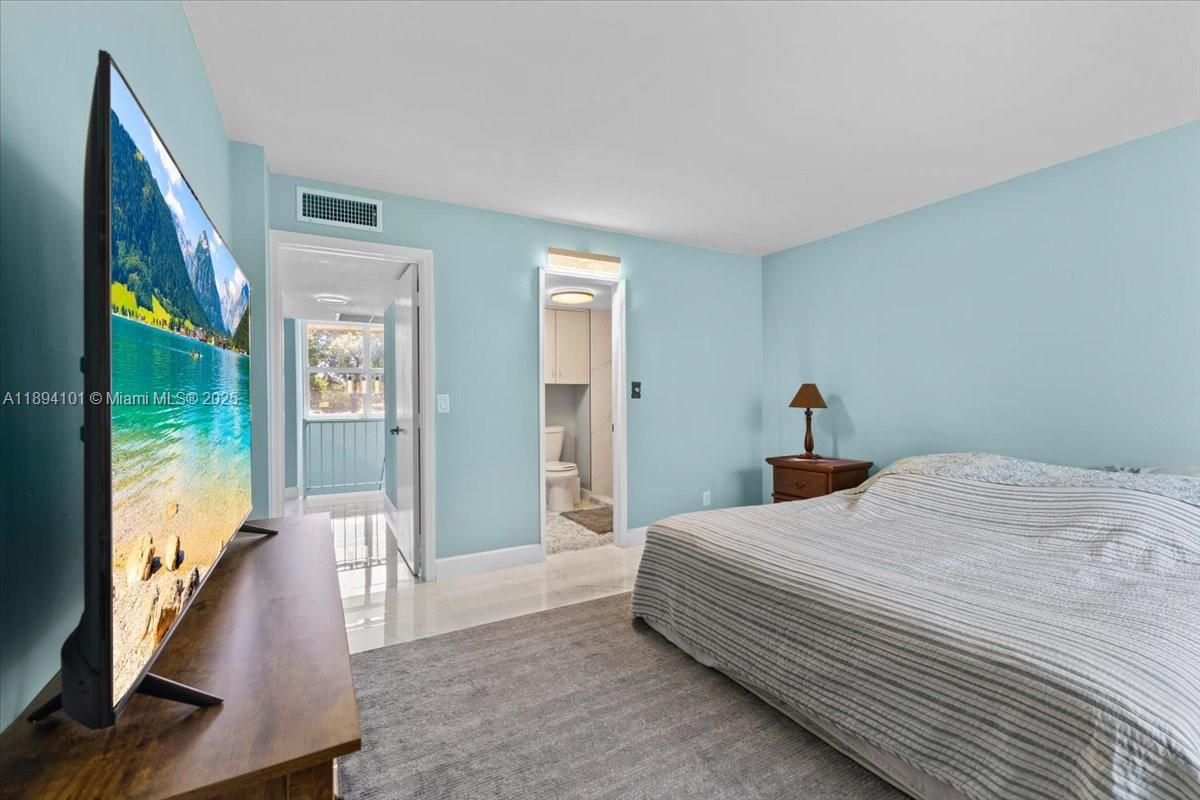 9450 Live Oak Place, Unit 109 Davie, FL 33324 - Photo 42 of 98 a bedroom with a balcony a bed and a large window