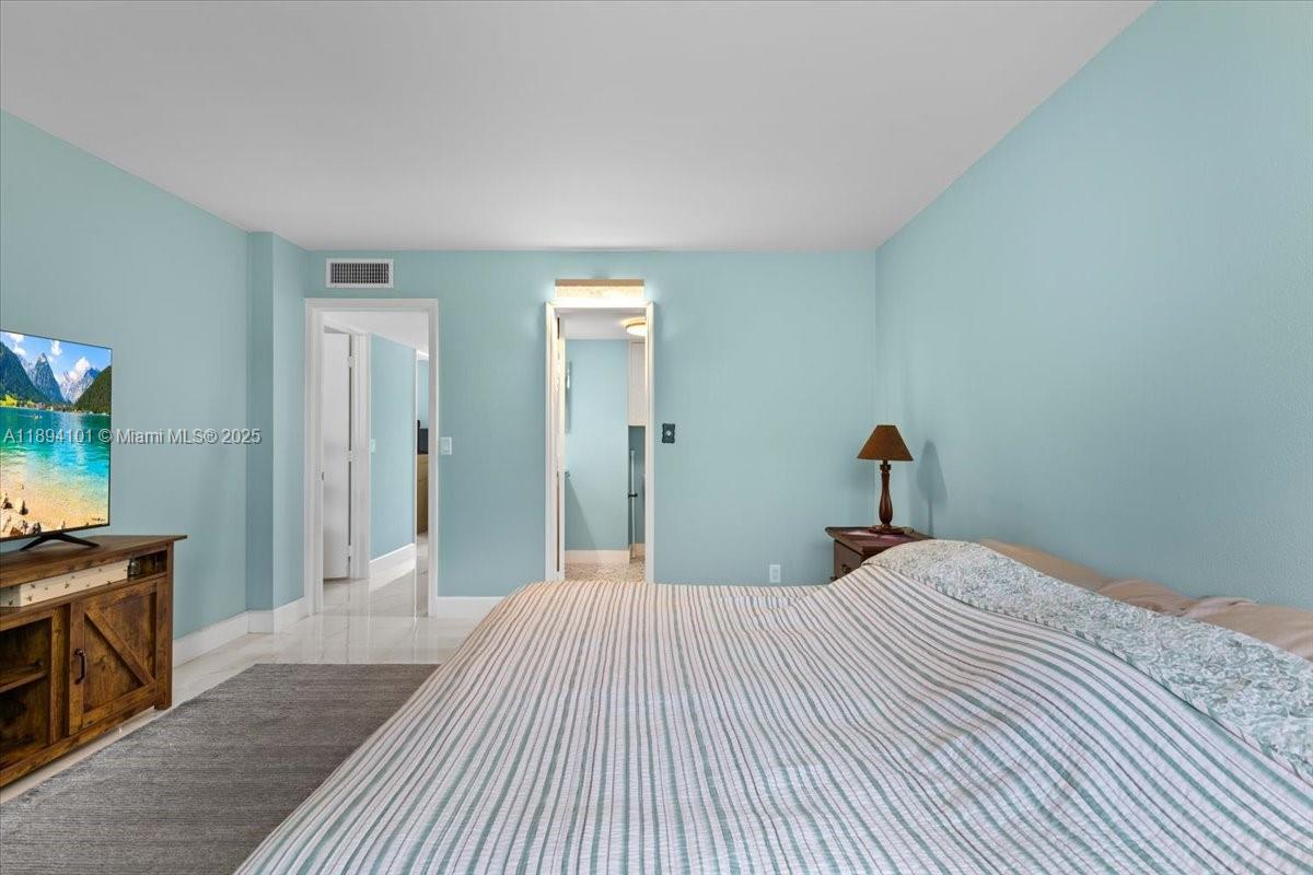 9450 Live Oak Place, Unit 109 Davie, FL 33324 - Photo 43 of 98 a bedroom with a bed and a flat screen tv