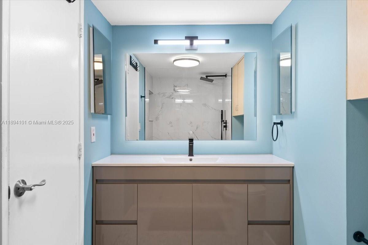 9450 Live Oak Place, Unit 109 Davie, FL 33324 - Photo 44 of 98 a bathroom with a sink and mirror