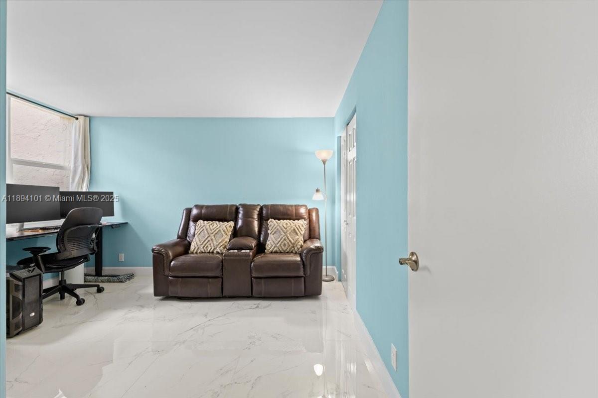 9450 Live Oak Place, Unit 109 Davie, FL 33324 - Photo 49 of 98 a living room with furniture and a flat screen tv