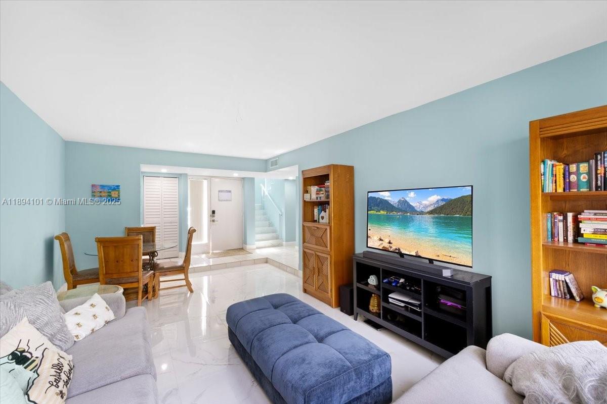 9450 Live Oak Place, Unit 109 Davie, FL 33324 - Photo 5 of 98 a living room with furniture and a flat screen tv