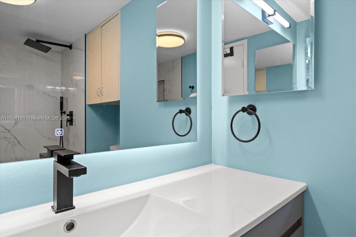 9450 Live Oak Place, Unit 109 Davie, FL 33324 - Photo 69 of 98 a bathroom with a sink and a mirror