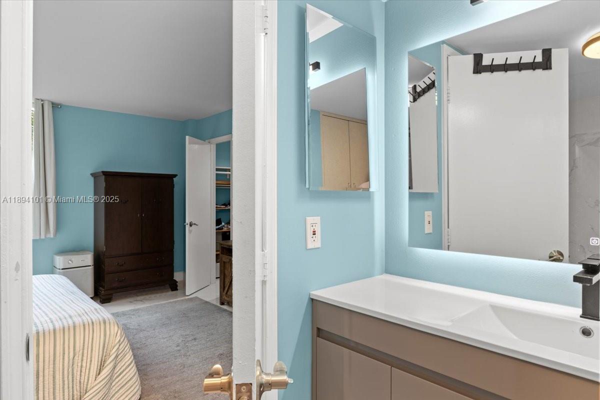 9450 Live Oak Place, Unit 109 Davie, FL 33324 - Photo 70 of 98 a bathroom with a sink and a mirror