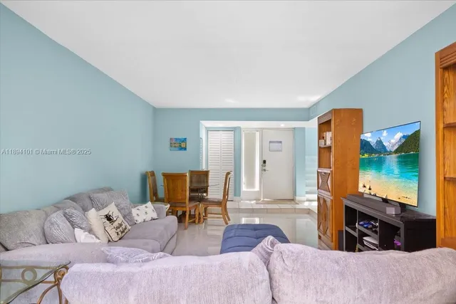 a kitchen with stainless steel appliances granite countertop a sink stove microwave and refrigerator