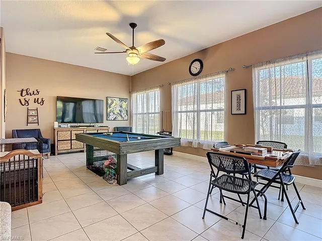 a living room with furniture a flat screen tv and a window