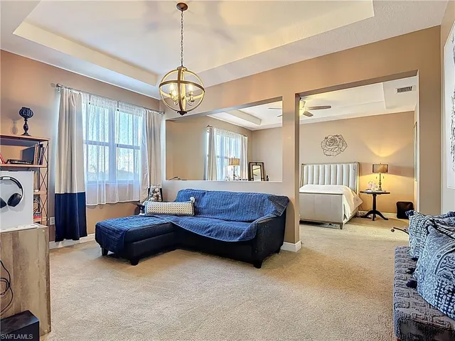 a spacious bedroom with a bed couch and a window