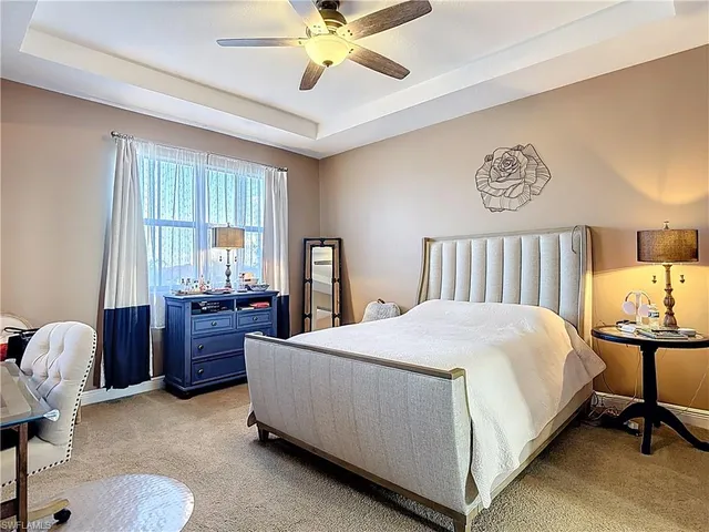 a bedroom with a bed and a dresser in it